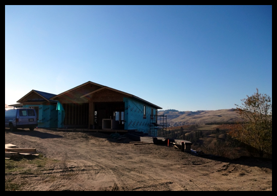 Building a Home in Coldstream, Fourth Month, the house is wrapped and hardi board is next.